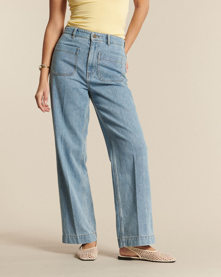 Jean femme en denim coton bleu clair, coupe droite et ample avec poches plaquées, conçu pour s’adapter à toutes les morphologies.